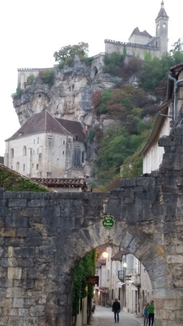 Rocamadour Rocamadour a church perched on a hill as seen through a arched bridge with ancient streets
