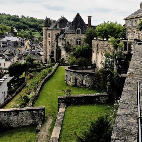 Uzerche Uzerche town walls and grassy banks with old turreted houses