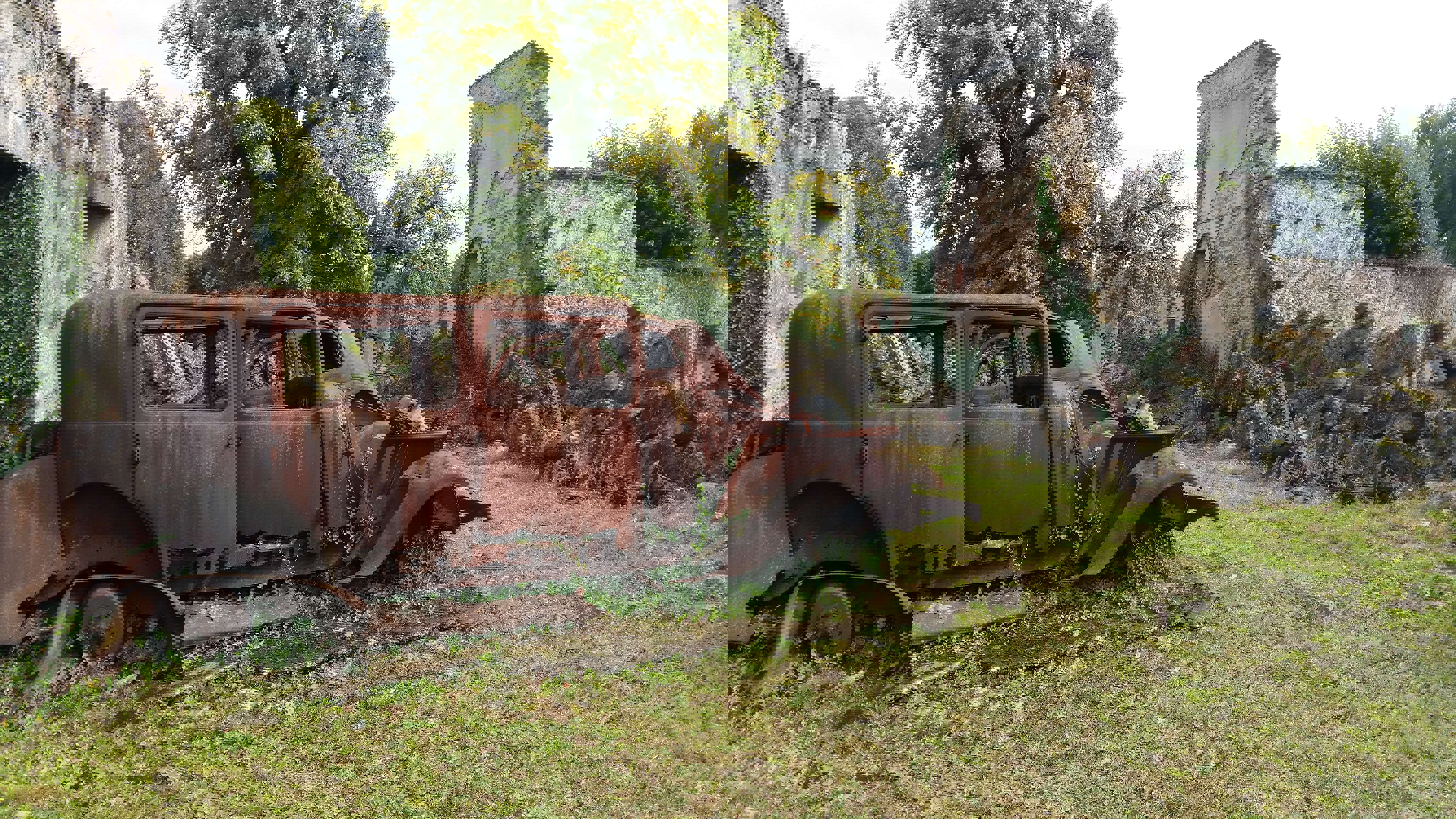 The preserved village of Oradour sur Glane Disused light grey buildings without roofs and 1940