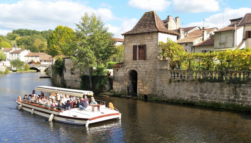 A flat-bottomed boat cruise on the River Dronne past the Benedictine Abbey, Brantôme, Dordogne