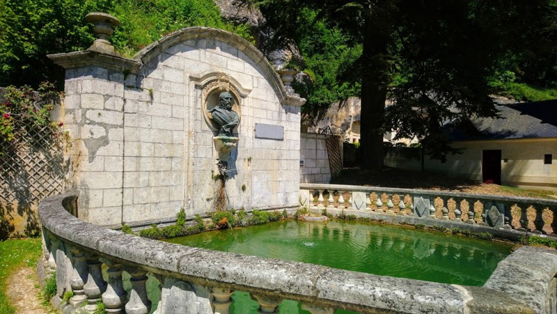 The riverside gardens and fountain of Le Jardin des Moines on the banks of the Dronne