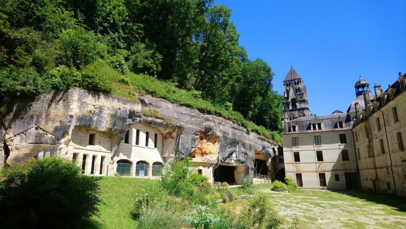 The troglodyte cave chambers of the Grottes de l'Abbaye carved into the limestone cliff at Brantôme