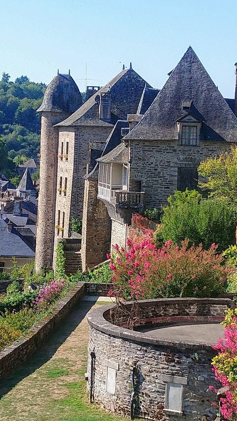 Uzerche Uzerche town walls and grassy banks with old turreted houses