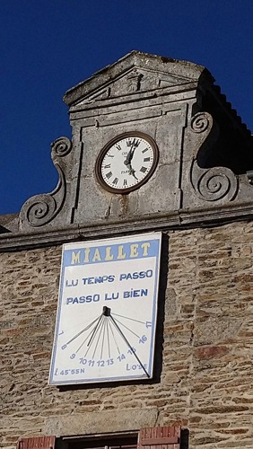 Clock on the old stone school building in Mialet Dordogne