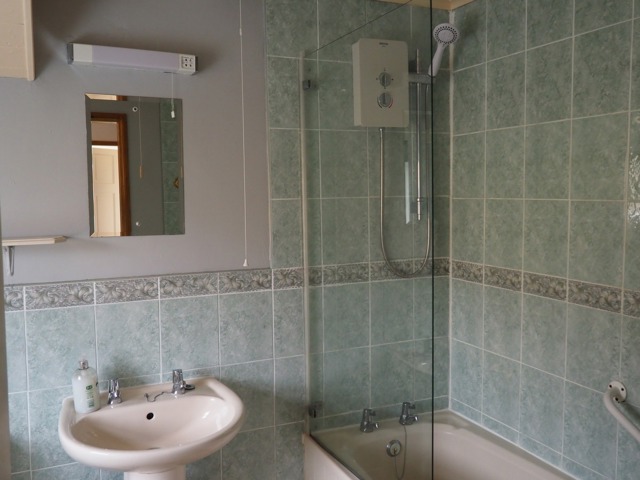 Bathroom with over bath shower at Belle View Cottage