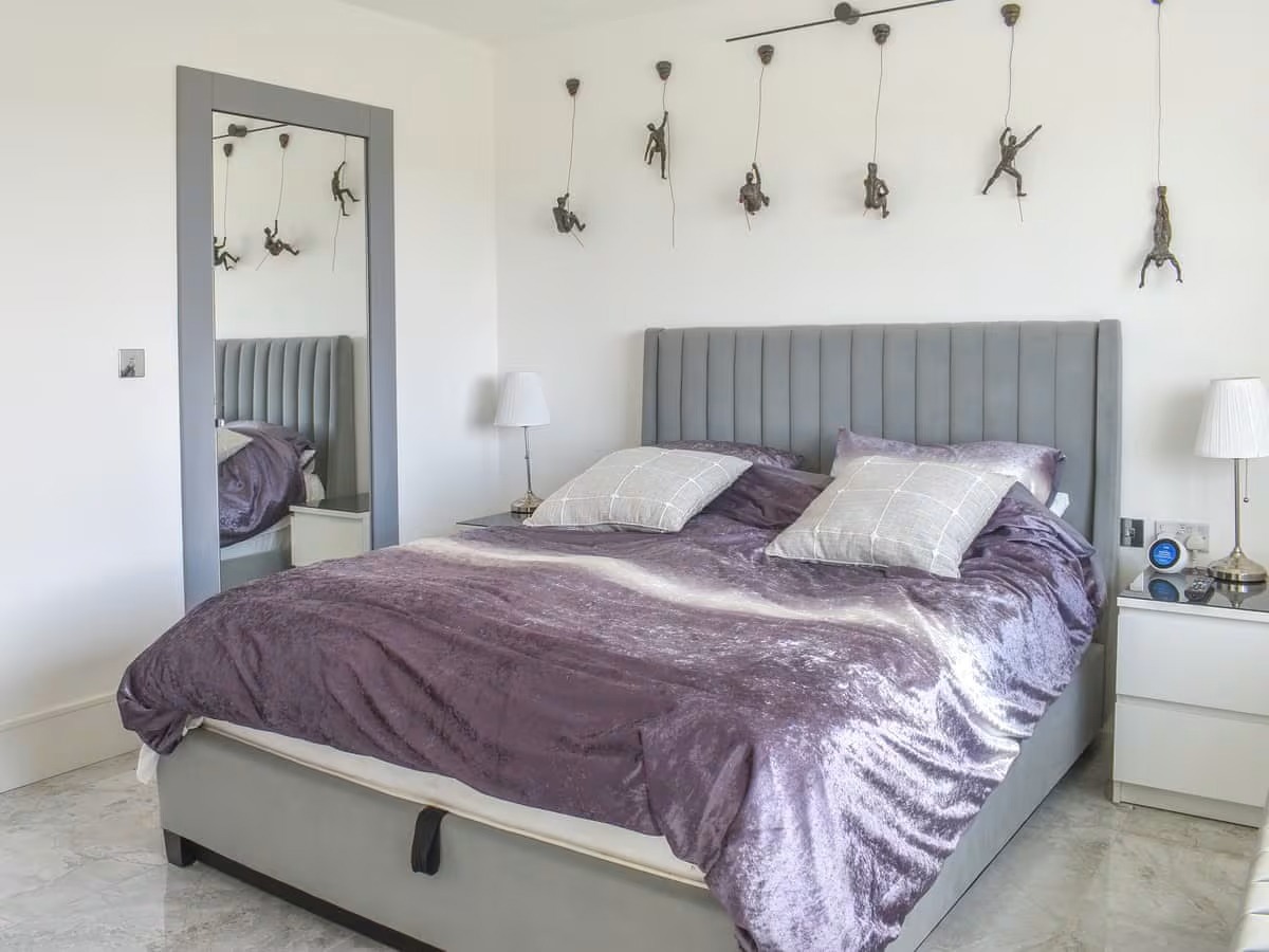 Spacious master bedroom at Seaside Place with king-size bed, en0suite shower room & direct sea views. Master Bedroom with Sea Views & Ensuite