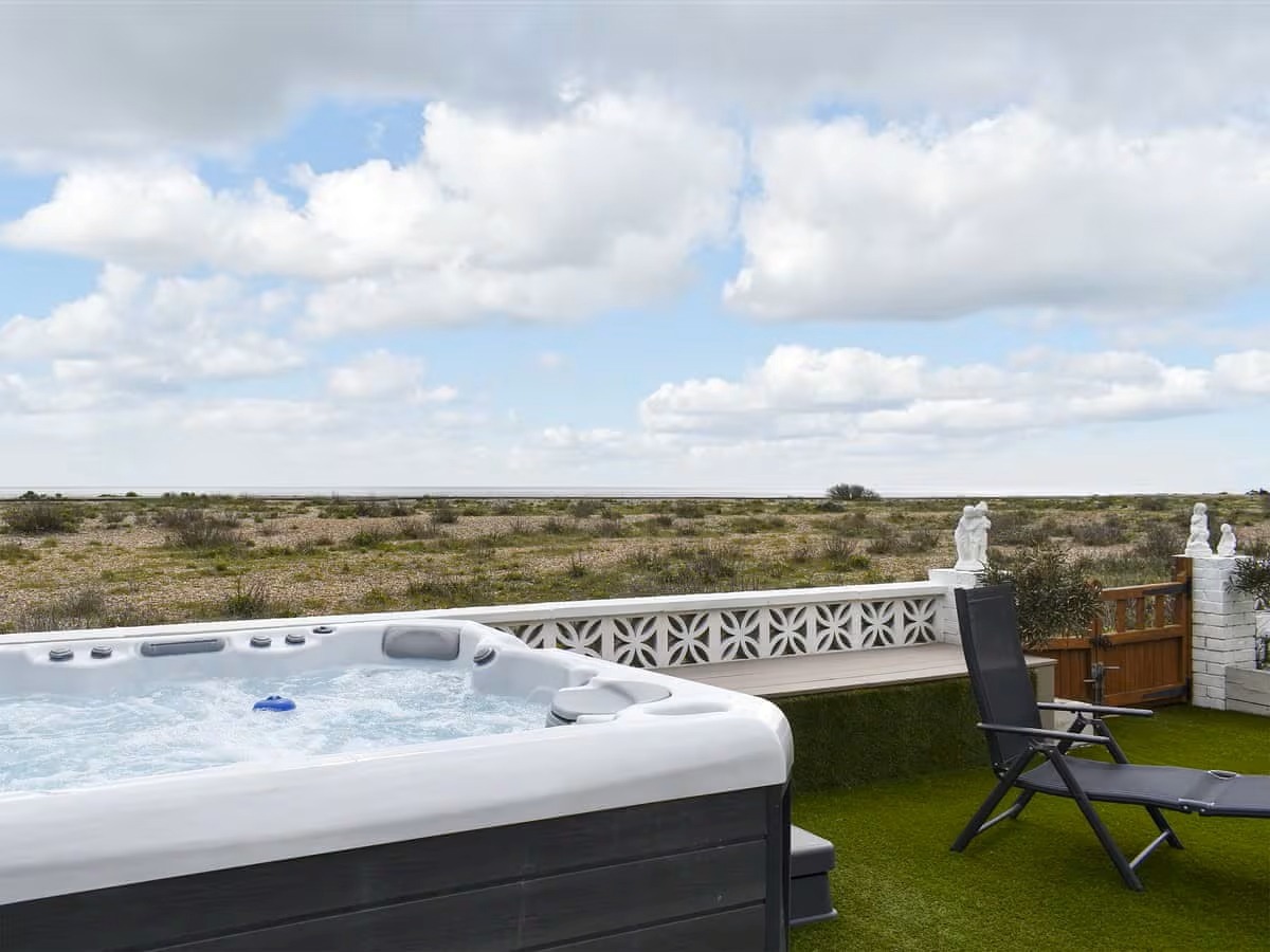Why choose between hot tub & beach when you can have both! Hot Tub next to the beach