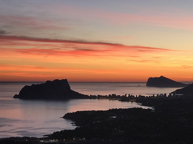 Sunset view from Cumbre del Sol down the coast to the Ifach rock
