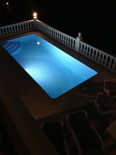 The heated pool at night with underwater lighting