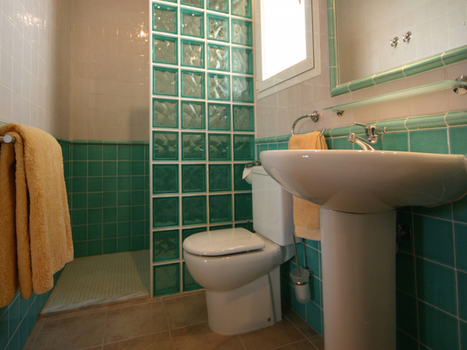 Master bedroom ensuite with glass walled shower and two basins