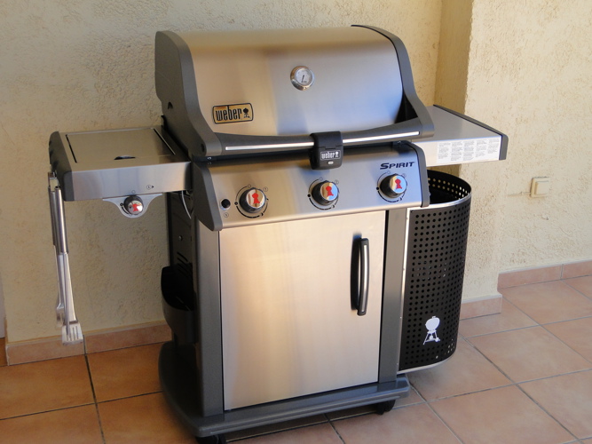 Weber gas barbecue (BBQ) with utensils on the terrace at Casa Windlenook