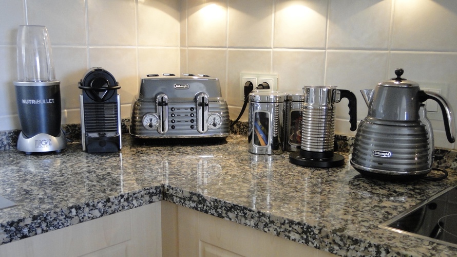 Gadgets in the kitchen include a Nespresso coffee machine, NutriBullet juicer, kettle and toaster
