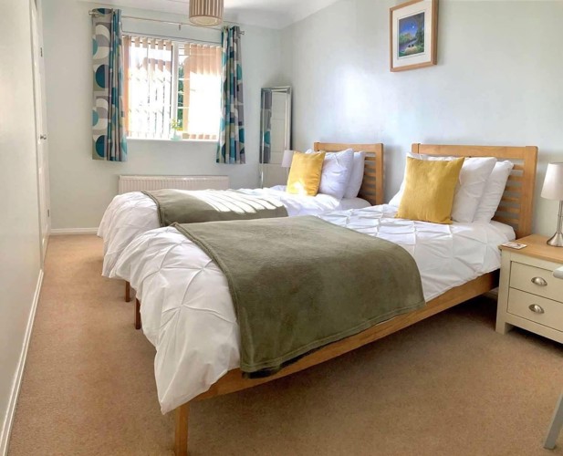 Image of two single beds in twin room at Moulton view holiday cottage