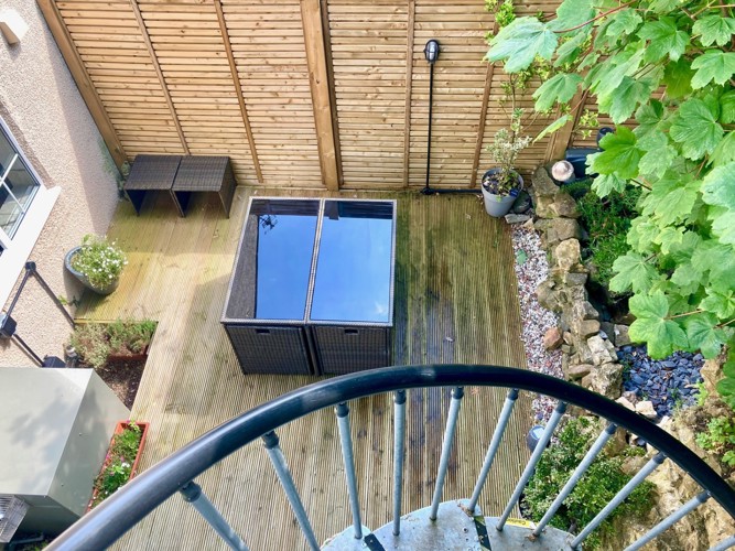 Image of lower fully decked garden from above at Moulton View Holiday Cottage