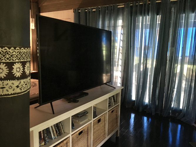65 inch LED TV with DVD player and remotes.