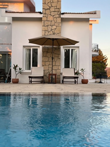 White villa exterior beside the private swimming pool