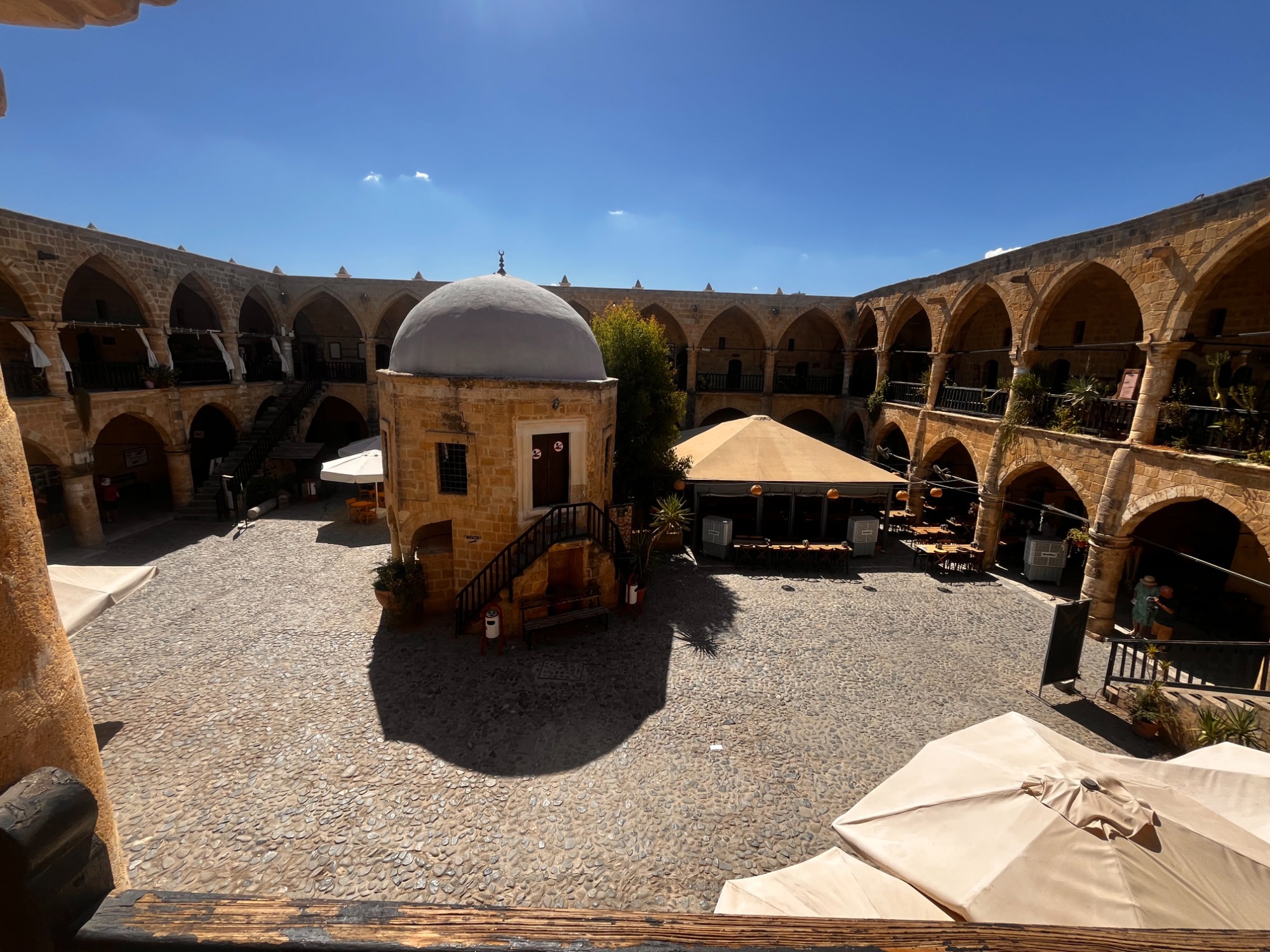 B&uuml;y&uuml;k Han courtyard in North Nicosia with upper gallery, caf&eacute;s and small shops