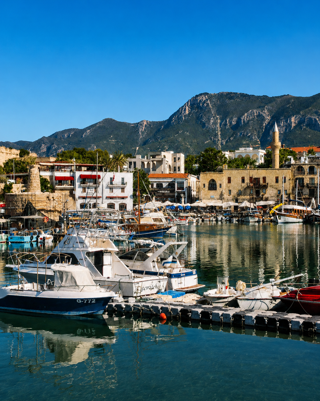 Traditional boats, waterfront restaurants and old buildings around Kyrenia Harbour