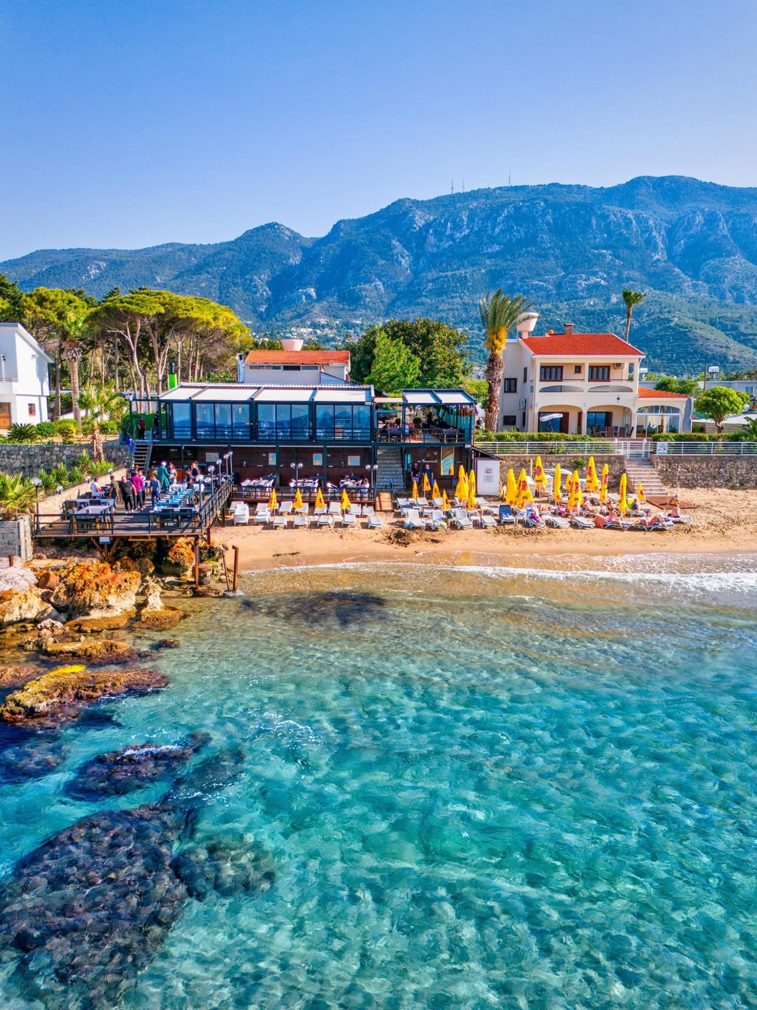 Driftwood restaurant on the Lapta coast with tables, terrace, beach and sea