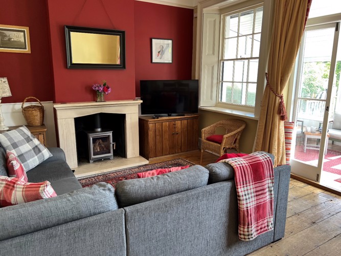 Relax in the cosy living room with Log Burner