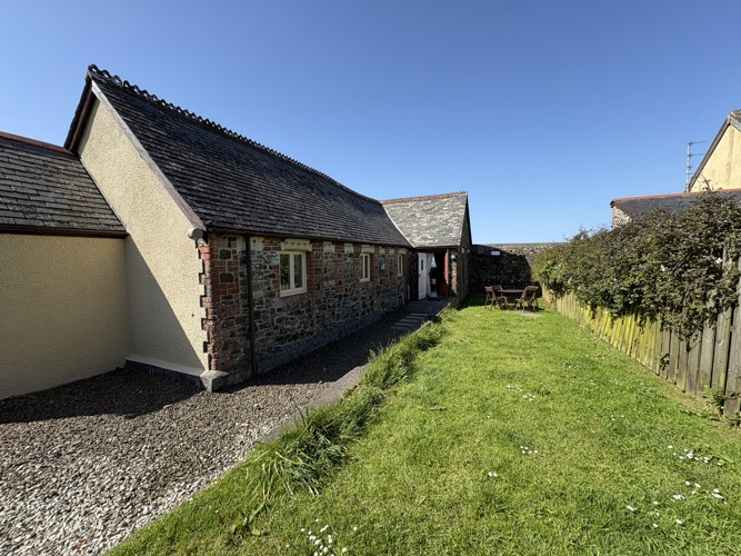 The fully enclosed rear garden, accessed from the Long Barn